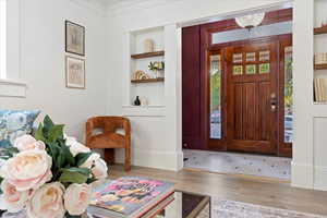 Entrance foyer with ornamental molding, Crystal Chandelier, and historic penny tile