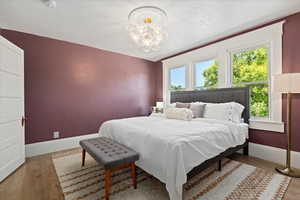 Master bedroom featuring designer lighting, medallion, and bright lighting