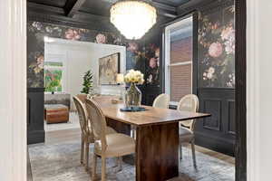 Dining room with Graham & Brown Wallpaper, Crystal Chandelier, Coffered Ceiling, Wainscoting, and open shelving