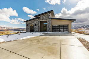 Contemporary house featuring a garage and a mountain view