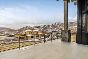 Snow covered back of property featuring a mountain view