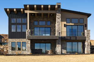 Back of house with a balcony