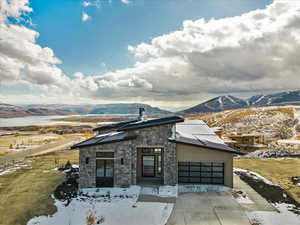 View of front of house featuring a mountain view and a garage