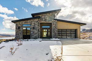 Contemporary house with a mountain view and a garage