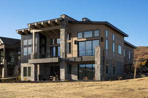 Back of house featuring a balcony