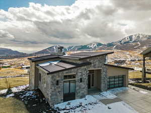 View of front of property featuring a mountain view and a garage