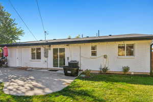 Rear view of property with a patio area, a lawn, and cooling unit