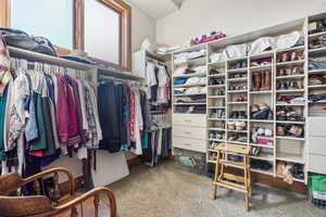 Walk in closet with carpet flooring