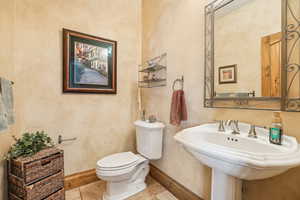 Bathroom with tile patterned floors, toilet, and sink