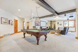 Recreation room featuring beamed ceiling, light colored carpet, and pool table