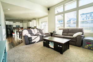 Living room with plenty of natural light and dark hardwood / wood-style flooring