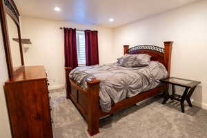 Bedroom with light colored carpet