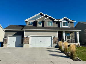 Craftsman-style home with a garage and covered porch