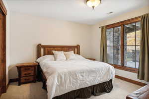 Bedroom featuring light colored carpet