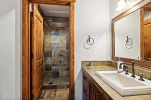 Bathroom with vanity and a tile shower