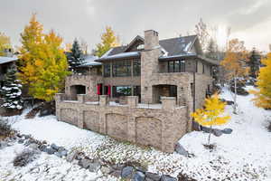 Snow covered property with a sunroom