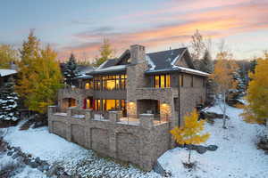 View of snow covered back of property