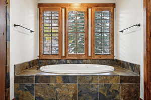 Bathroom featuring tiled bath