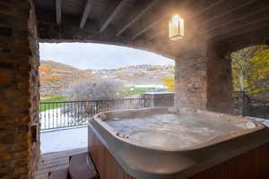 View of patio with a hot tub