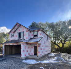 Property in mid-construction featuring a garage