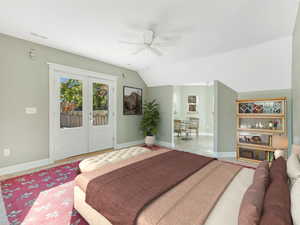 Bedroom with access to outside, visible vents, lofted ceiling, and baseboards