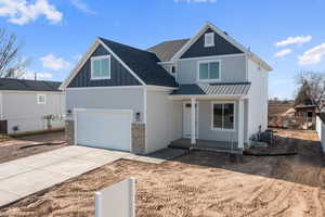 View of front of home featuring central AC and a garage