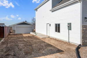 View of home's exterior with a detached garage and basement entrance for potential ADU