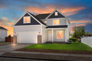 View of front facade featuring concrete driveway, attached garage, stone siding, board and batten siding, and AC cooling unit