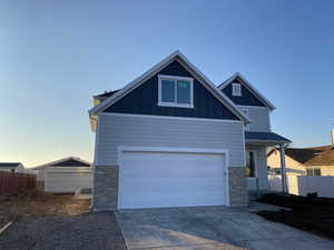 Craftsman-style house featuring detached garage