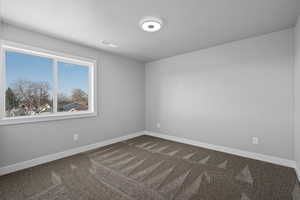 Bedroom 3 with carpet flooring and a textured ceiling