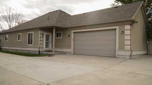 View of the rear of the property with a garage