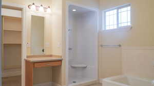 Master Bathroom with a walk-in shower and deep soaking bathtub and vanity