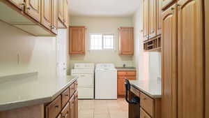 Entry from Garage, Laundry with sink, office built-in desk, extra storage Cabinets