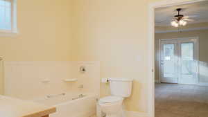 Master Bathroom featuring soaking tub to relax in, vanity, and toilet