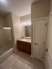 2nd Full Bathroom featuring vanity, tile patterned flooring, and enclosed tub / shower combo