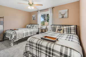 Carpeted bedroom with ceiling fan