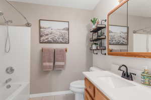 Full bathroom featuring shower / washtub combination, tile patterned flooring, vanity, and toilet