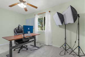 Carpeted office with ceiling fan