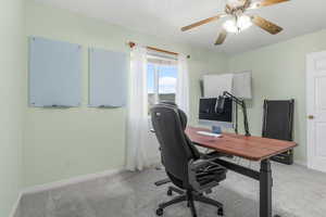 Carpeted office space with ceiling fan