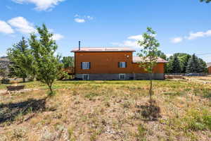 Rear view of property featuring central air condition unit