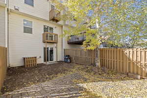 Rear view of property with a patio and a balcony