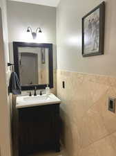 Bathroom with tile walls and oversized vanity