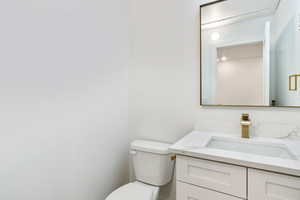 Bathroom featuring vanity and toilet