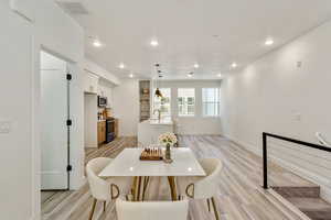 Dining room with light hardwood / wood-style flooring