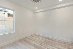 Empty room with light hardwood / wood-style floors