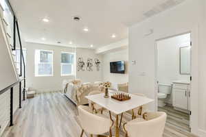 Dining area with light hardwood / wood-style flooring