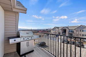 Wooden deck with a residential view and a grill