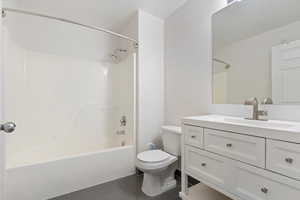 Full bathroom with toilet, tile patterned flooring, bathtub / shower combination, and vanity