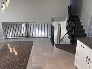 Stairs with tile patterned floors