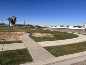 View of home's community with a lawn